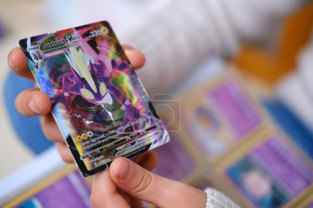 Photo for Positive child playing with Pokemon Trading Card Game, collectible card game for children, Battle with friends, Educational Games, Pokemon Fan Culture, Frankfurt - October, 28, 2023 - Royalty Free Image