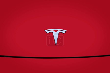 Photo for Closeup chromium-plated Logotype Tesla Motors on red hood, most popular passenger electric car in world, Elon Musk, Tesla American company, electric vehicle production, Frankfurt - December 8, 2022 - Royalty Free Image