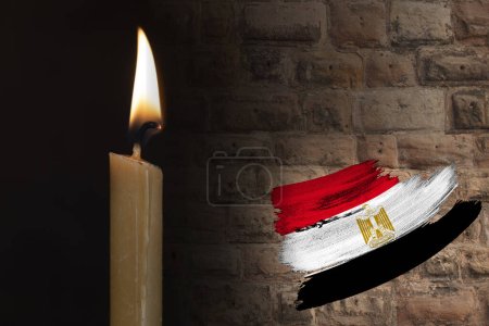 mourning candle burning front of flag Egypt, memory of heroes served country, grief over loss, national unity in challenging times, state's history