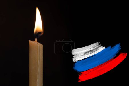 mourning candle burning front of flag Russia, memory of heroes served country, grief over loss, national unity in challenging times, state's history