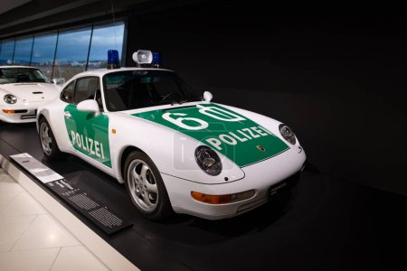 Photo for Vintage white and green police sports car Porsche 911 Carrera, Oldtimer car collection, retro-style, nostalgia and automotive history, exhibition Museum Porsche, Stuttgart, Germany - January 26, 2024 - Royalty Free Image