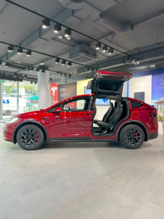 Photo for Ultra Red electric vehicle Tesla model X Falcon Wing in Studio, Environmental sustainability, alternative energy development concept, Elon Musk company, Frankfurt, Germany - September 26, 2023 - Royalty Free Image