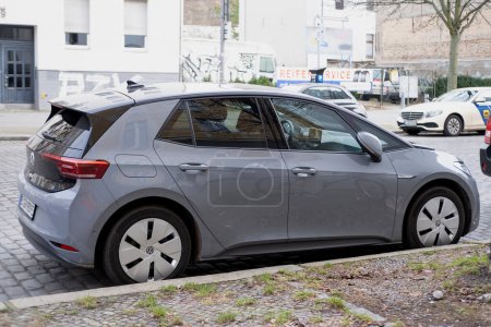 Foto de Moderno coche gris Volkswagen ID.3 en la calle de Berlín, ecológico VW vehículo eléctrico en el medio ambiente urbano, industria automotriz, transporte sostenible, Berlín, Alemania - 18 de febrero de 2024 - Imagen libre de derechos