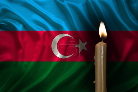 mourning candle burning front of flag Azerbaijan, memory of heroes served country, grief over loss, national unity in challenging times, state's history