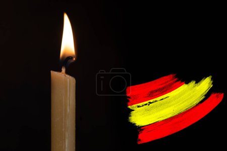 mourning candle burning front of flag Spain, memory of heroes served country, grief over loss, national unity in challenging times, state's history
