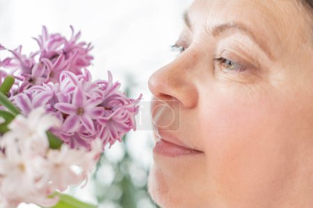 close-up Female face lights up with delight savors sweet scent hyacinth, capturing joy of springtime and beauty of nature, while also raising awareness of seasonal allergies, Sensory Experience