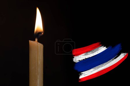 mourning candle burning front of flag Thailand, Victims of cataclysm or war concept, memory of heroes served country, grief over loss, national unity in challenging times, state's history