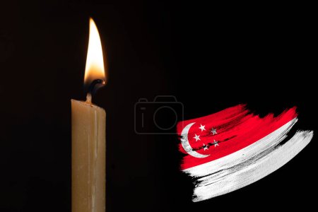 mourning candle burning front of flag Singapore, memory of heroes served country, grief over loss, national unity in challenging times, state's history