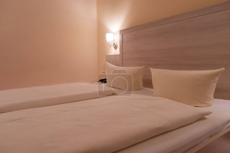 Luxurious hotel room interior with cozy double bed covered in pristine white bedding, perfect for relaxation and comfort, high quality services provided in hotel industry, Service Quality