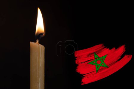 mourning candle burning front of flag Morocco, memory of heroes served country, grief over loss, national unity in challenging times, state's history