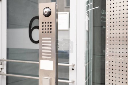 outdoor modern wireless interphone in front of office, intercom to communicate with visitors, stand-alone communication tool, metal call panel to control the movement of people