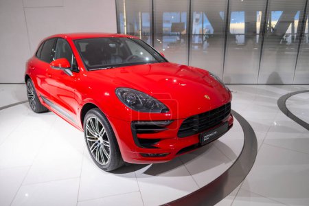 Photo for New red Porsche Macan Turbo, 4x4 all-wheel drive, elegance sports Car in showroom, sustainable development, Innovation in automotive industry Porsche AG show in Stuttgart, Germany - January 26, 2024 - Royalty Free Image