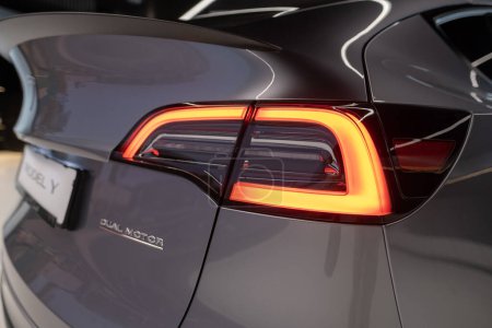 Photo for Closeup taillights of grey electric tesla model y performance quicksilver rear view, automotive industry, crossover SUV, Environmental sustainability, Berlin, Germany - February 18, 2024 - Royalty Free Image