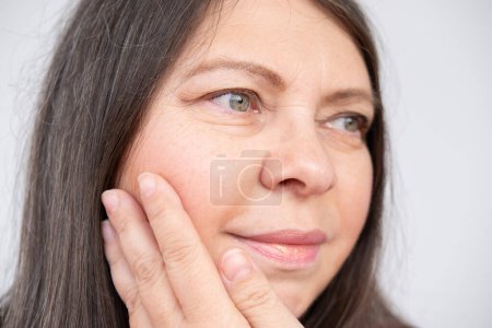 closeup face mature woman 55 years old, human fat neck, side view, double saggy chin, deep wrinkles, age-related skin changes, cosmetic anti-aging procedures, skin tightening