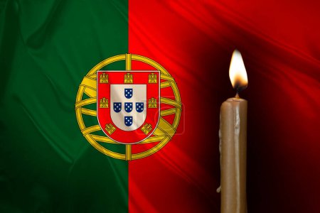 mourning candle burning front of flag Portugal, memory of heroes served country, grief over loss, national unity in challenging times, state's history