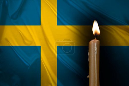 mourning candle burning front of flag Sweden, memory of heroes served country, grief over loss, national unity in challenging times, state's history