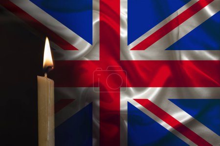 mourning candle burning front of flag United Kingdom, memory of heroes served country, grief over loss, national unity in challenging times, state's history