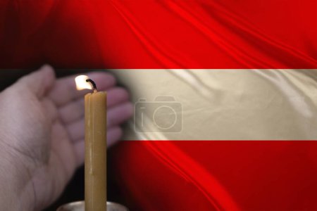 mourning candle burning front of flag Austria, Victims of cataclysm or war concept, memory of heroes served country, grief over loss, national unity in challenging times, state's history