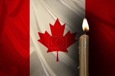mourning candle burning front flag Canada, Victims cataclysm or war concept, memory heroes served country, grief over loss, national unity in challenging times, state's history