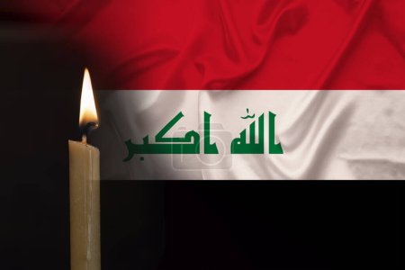 mourning candle burning front of flag Iraq, memory of heroes served country, grief over loss, national unity in challenging times, state's history