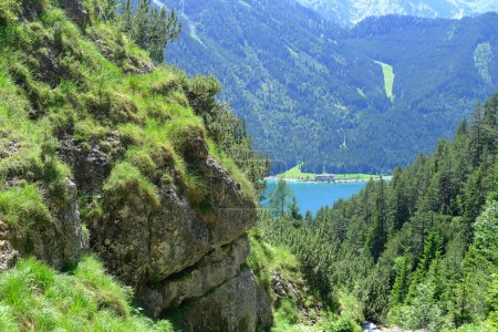 Scenic view green Alpine mountains and blue serene lake, mountain range in Europe, challenging terrain, picture breathtaking inherent beauty natural world, untouched by human