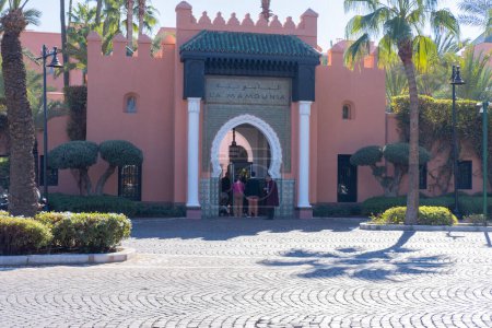 Photo for People go to Moroccan hammam, bathhouse, Red City Marrakech, authentic urban African landscape, daily activities and interactions people living in city Marrakech, Morocco - January 7, 2024 - Royalty Free Image