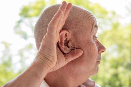 caucasian mature man difficulty hearing, cerumen impaction, hearing loss, medical concept, loud sounds, middle ear inflammation, ototoxic medicines