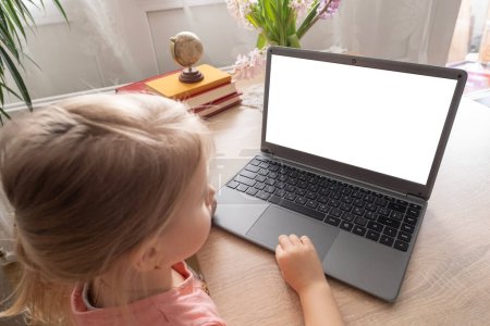 Photo for Preschool girl studying distance learning course, using computer, monitor with white screen mockup, Digital literacy, Parenting in digital age, cyber education, screen time - Royalty Free Image