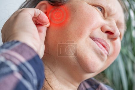 caucasian mature woman holding painful ear close up, hearing loss, Ear Discomfort, Health, Acute Otitis Media, Treatment and Care, Diagnosing and Treating, Preventing Ear Issues