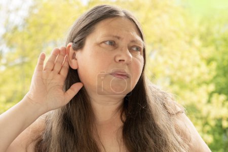 caucasian mature woman difficulty hearing, cerumen impaction, hearing loss, medical concept, loud sounds, middle ear inflammation, ototoxic medicines