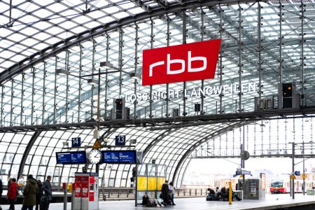 Photo for Radio news Berlin-Brandenburg logo on arched metal vault at train station, glass-enclosed platform, modern railway infrastructure and branded transportation hubs, Berlin, Germany - February 19, 2024 - Royalty Free Image