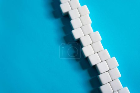 Photo for Chain of blocks on a blue background. Abstraction structure. concept of organization and strength. Unity and Consolidation. Orderly system. Stability, steadfastness. Construction and creation - Royalty Free Image