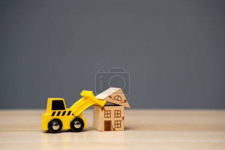 Photo for The bulldozer demolishes the house. Encroachment on private property. Illegal buildings and construction. Violation of building codes. Housing renovation. Renovation of an old real estate fund. - Royalty Free Image