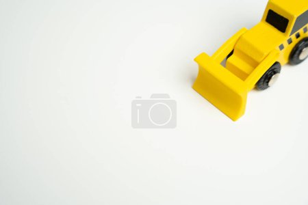 Photo for Yellow toy bulldozer, top view copy space. Demolition services, land leveling and other land works. Building destruction. Take down Illegal construction. Industry machinery for rent - Royalty Free Image