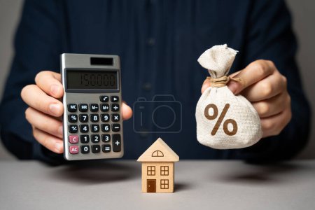 Photo for Calculate the value of your home on a loan. Utilities and services expenses. Taxes, home budget. Real estate valuation. Buying and selling. Building maintenance. Mortgage payments. Save money - Royalty Free Image