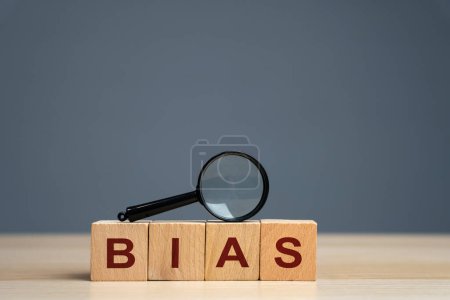 Bias word on a wooden blocks. Prejudice. Personal opinions. Preconception. Concept of facts and biases. Magnifying glass