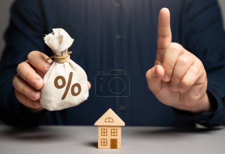 Photo for The man warned the buyer of real estate. Weigh all the risks when buying real estate with a mortgage. Financial adviser warns. Investment brings benefits without jeopardizing finance stability. - Royalty Free Image