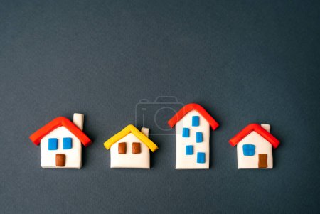 House figures. Realtor services. Find most suitable housing options. Valuation of residential buildings. Offers on real estate market. Copy space, place for text. Buying and selling.