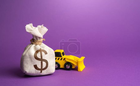 Photo for Bulldozer and dollar money bag. Construction equipment rental. Demolition services, land leveling and other land works. Industry machinery for rent. Take down Illegal buildings. - Royalty Free Image