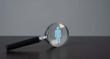 Photo for Symbol of a man in a magnifying glass. Finding people for work. Recruitment process, a search for workers to join a team or project. Quest for talent and unique qualities in candidates. - Royalty Free Image