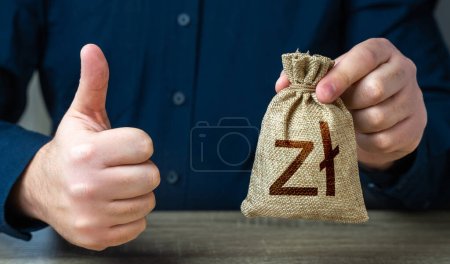 The man approves the deal or loan. Profit generating deposits savings. Thumbs up and polish zloty money bag. Agreement to be hired for a job at the offered salary.