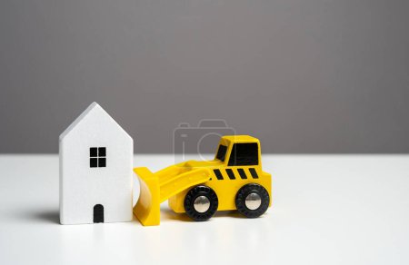 Photo for The bulldozer intends to demolish the house. Tearing down a house. Making way for future developments. - Royalty Free Image