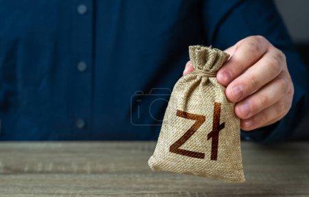 Photo for A man holds polish zloty money bag. Deposits and savings. Banks and finance. Investments, fundraising. Funding and grants. Loans, mortgage. Economics and currency exchange, stock market. - Royalty Free Image