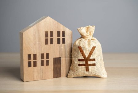 Wooden house figure and chinese yuan or japanese yen money bag. Taxes. Buying and selling real estate. Property value appraisal. Make a deal. Property Insurance. Housing prices.