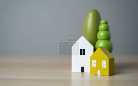 Cute figurines of houses and trees. Buy a nice house. Mortgage loan. Affordable housing. Housing search and realtor services