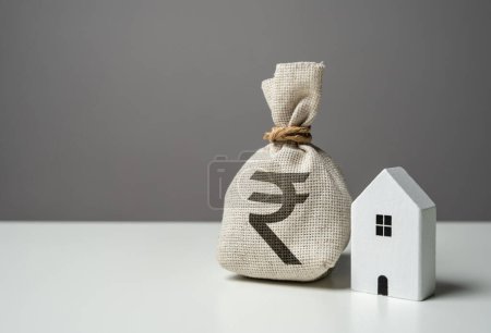 House and indian rupee money bag. Investments in the purchase of real estate. Repair and service. Make a deal. Insurance. House price, property valuation.