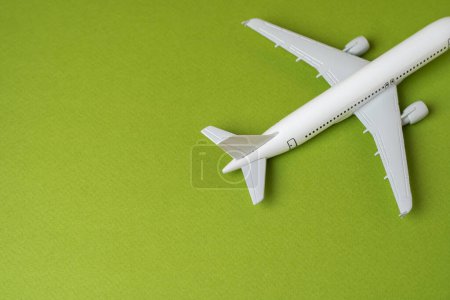 Photo for Airlines plane on a green background. Planning your trips. Additional service at airports. Arrival and departure. Business and tourism. Airline. Booking flight tickets. Ecology and success concept. - Royalty Free Image