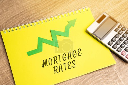 Mortgage interest rates growth concept. Raising mortgage rate and increase in interest charges. Loan for housing, real estate. Inscription with arrow up and calculator