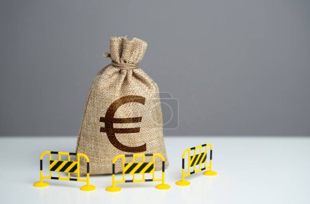 Euro money bag is fenced with barriers. Capital restrictions. Limiting the amount of money flowing in or out. Limit investment opportunities. Prevent rapid fluctuations in exchange rates.