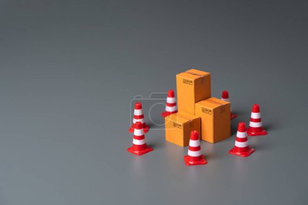 Photo for Boxes bounded by traffic cones. Cargo seizure and export restrictions. Economic impediments. Affecting economies and businesses, dependent on the uninterrupted exchange of goods - Royalty Free Image